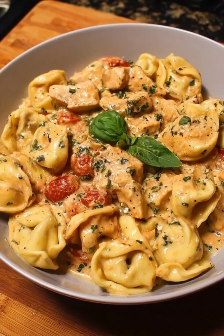 CrockPot chicken tortellini dish garnished with herbs