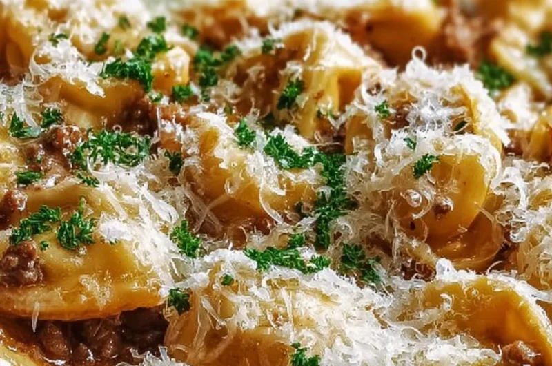 Creamy beef tortellini dish topped with Parmesan cheese