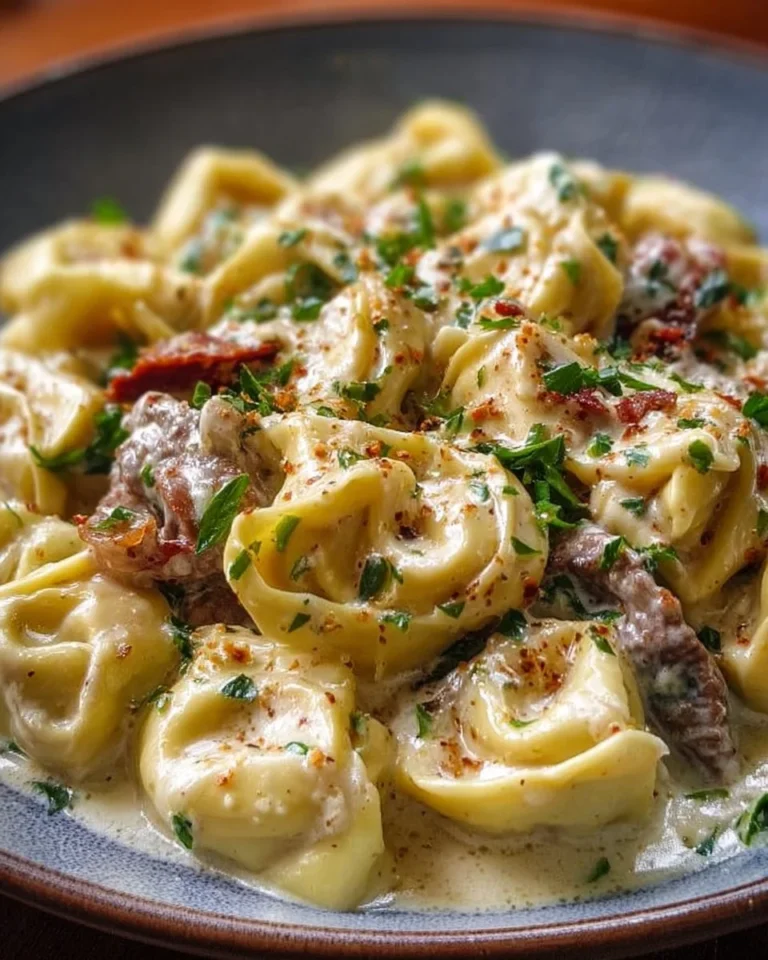 Cheesesteak tortellini in creamy provolone sauce served in a bowl