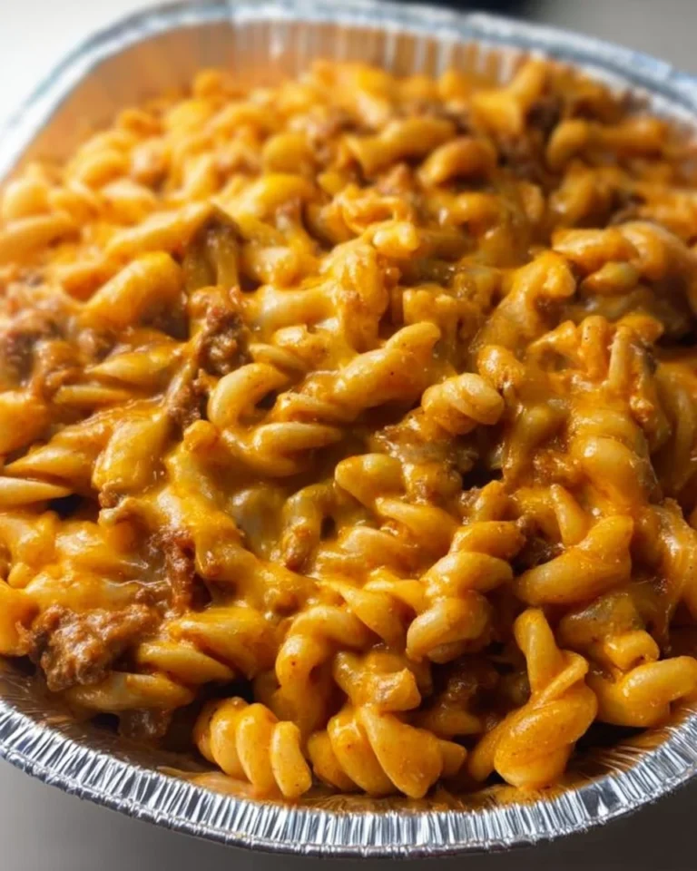 Cheesy taco cream cheese pasta served in a bowl with toppings