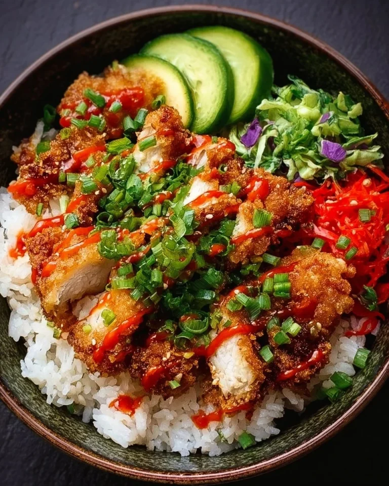 Crispy Bang Bang Chicken Bowl garnished with fresh vegetables and sauce
