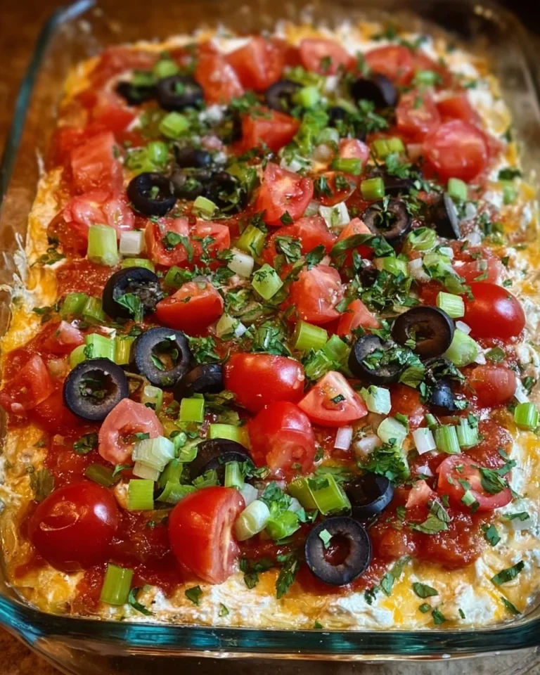Delicious Greek 7 Layer Dip served in a bowl with fresh ingredients