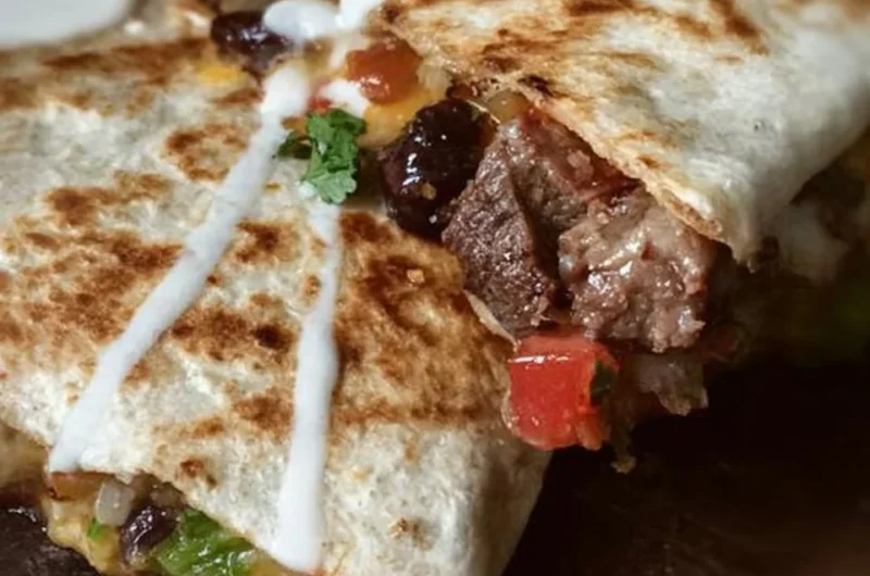 Delicious loaded steak quesadillas with cheese and toppings
