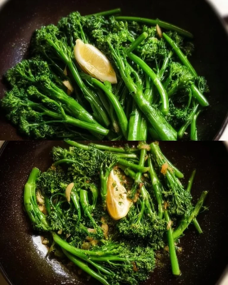 Sautéed lemon garlic broccolini on a white plate garnished with lemon slices.