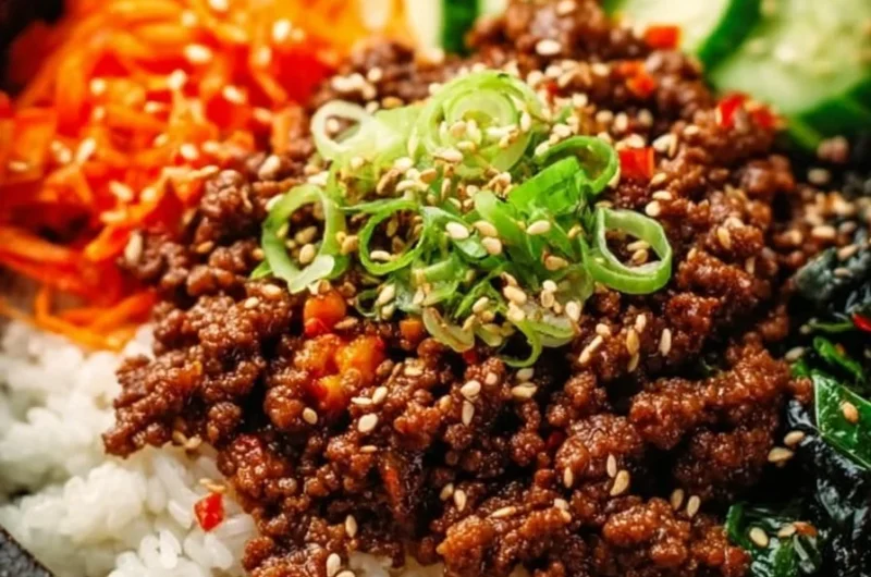 A delicious Korean Ground Beef Bowl garnished with vegetables and sesame seeds.