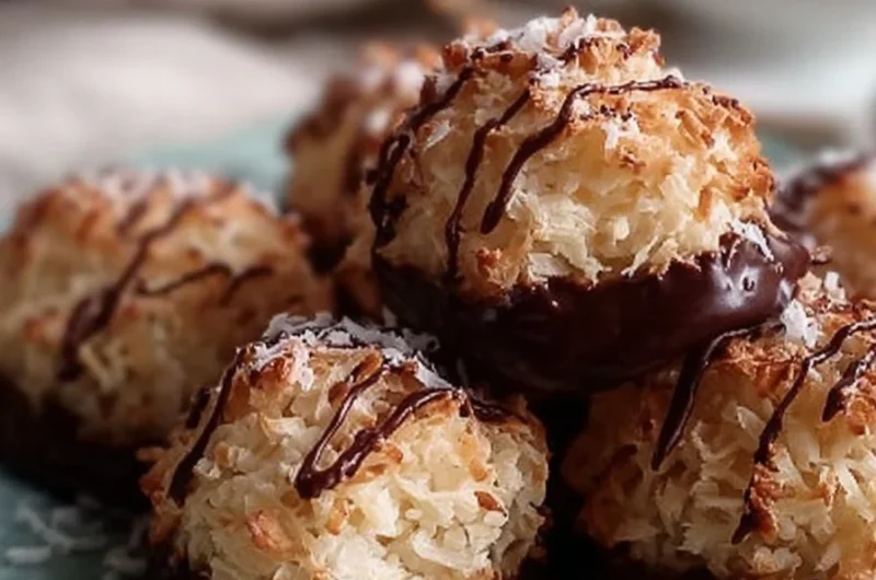 Delicious chocolate-dipped coconut macaroons on a white plate