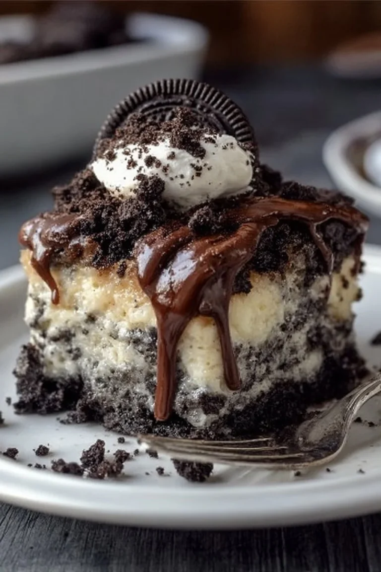 Delicious Oreo Dump Cake topped with crushed Oreos and cream.