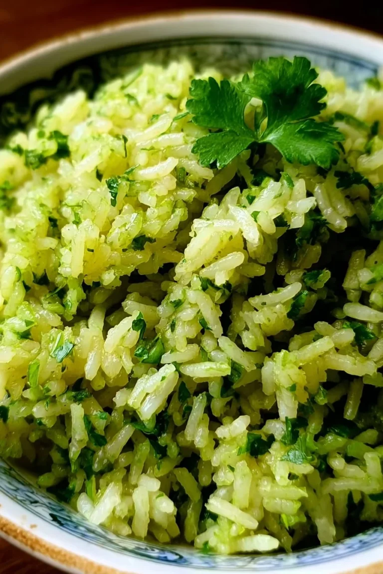 Vibrant green rice side dish garnished with fresh herbs