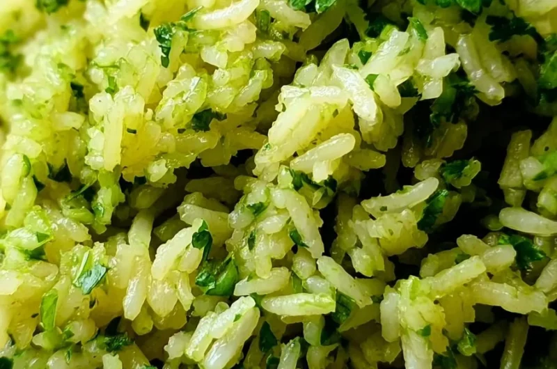 Vibrant green rice side dish garnished with fresh herbs