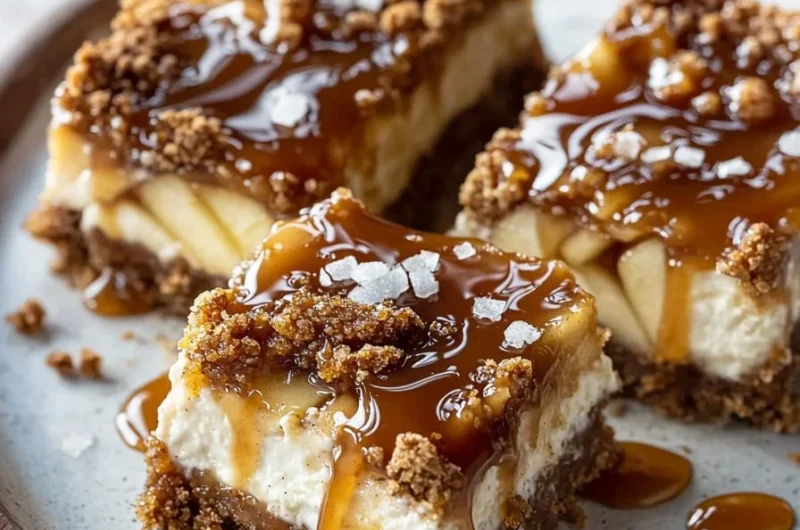 Cozy caramel apple cheesecake bars topped with caramel and apple slices