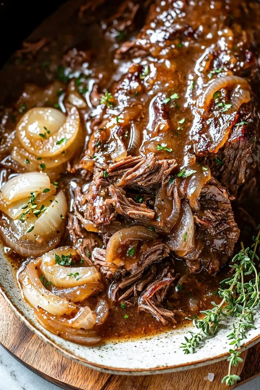 Crockpot French Onion Pot Roast served with herbs and onions