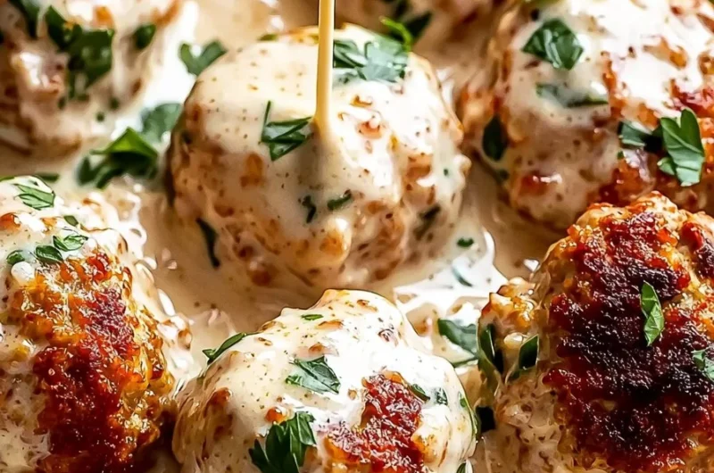 Creamy Marry Me Chicken meatballs served on a plate with herbs and sauce