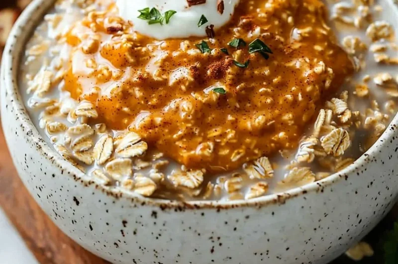 Bowl of easy pumpkin spice overnight oats topped with nuts and spices