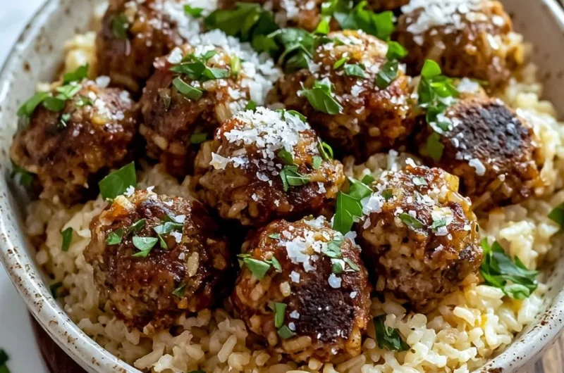 Ground beef meatballs served in a rice bowl with fresh herbs and spices