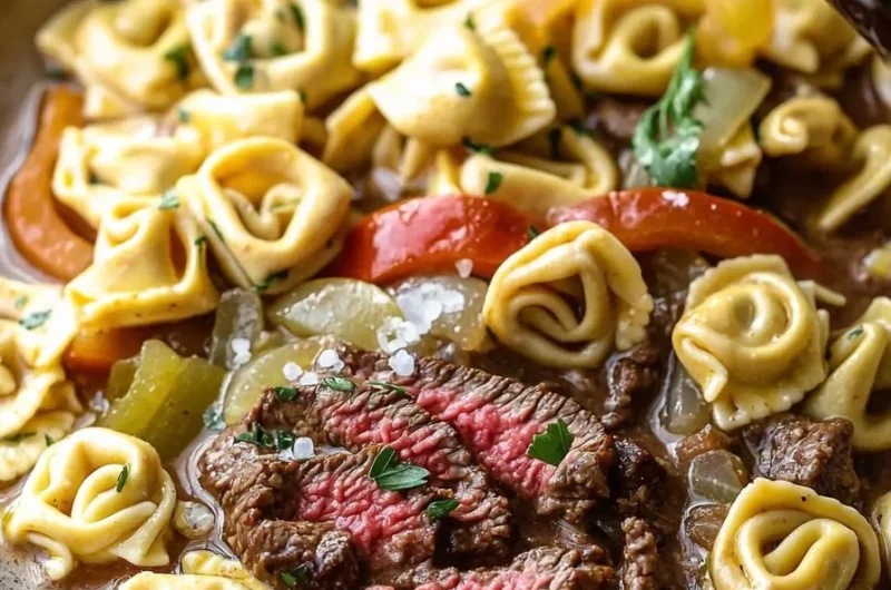 Bowl of Slow Cooker Cheesesteak Tortellini with peppers and cheese