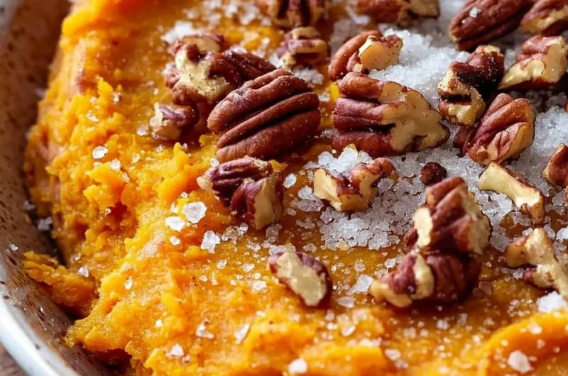 Delicious sweet potato casserole with pecan topping served in a dish