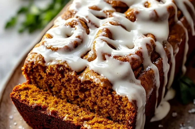 Delicious cinnamon roll pumpkin bread with cream cheese glaze on a plate