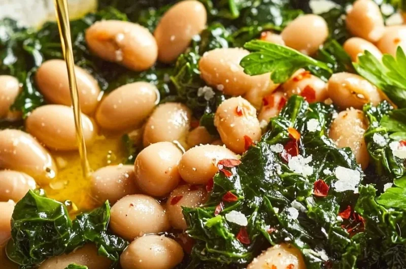 Bowl of easy Mediterranean white beans and greens, garnished with herbs