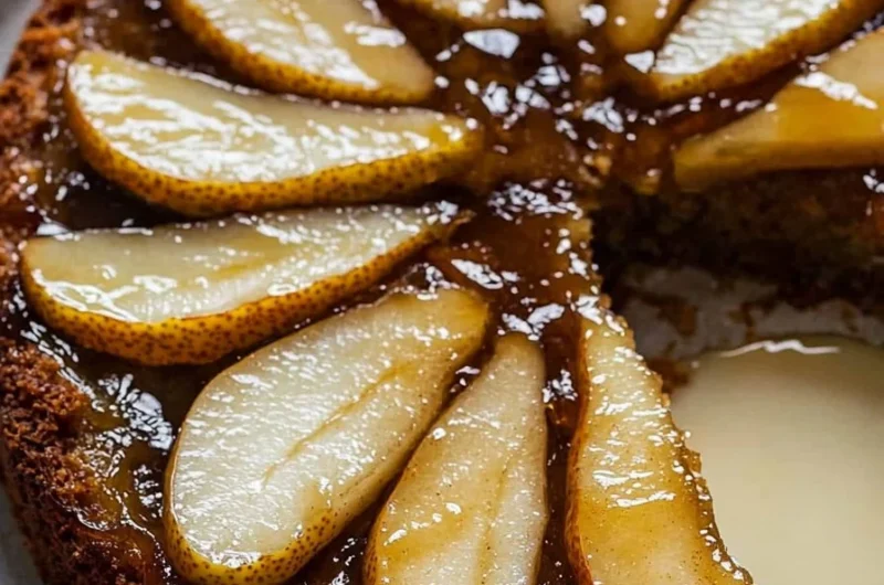Spiced pear upside down cake garnished with fresh pears and spices