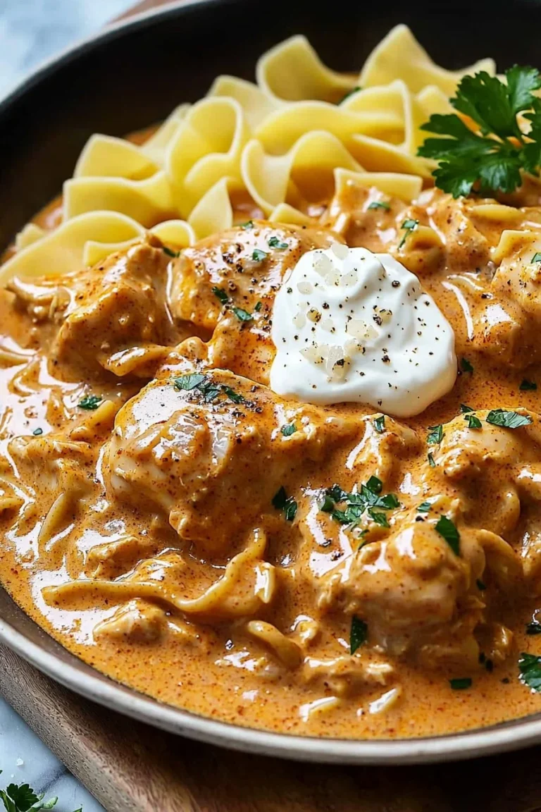 Creamy chicken paprikash served with egg noodles on a plate