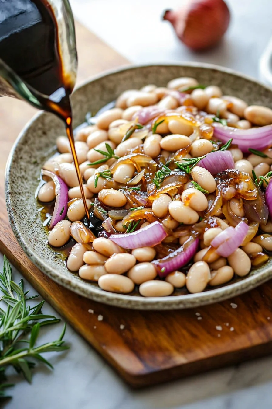 Caramelized onion white beans dish with rosemary and balsamic glaze