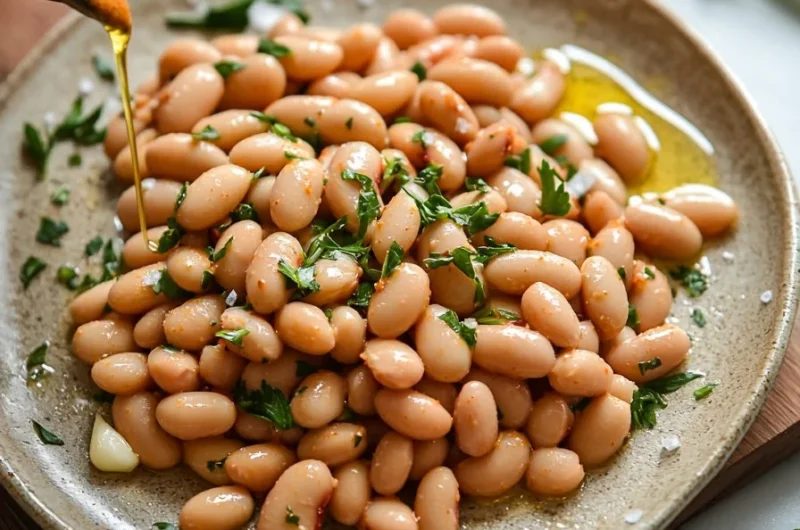 Bowl of Harissa Butter Beans served with herbs and spices, highlighting vibrant flavors